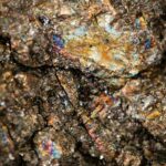 Close-up of chalcopyrite, pentlandite, and pyrrhotite mineral specimens used to illustrate mining laboratory testing.