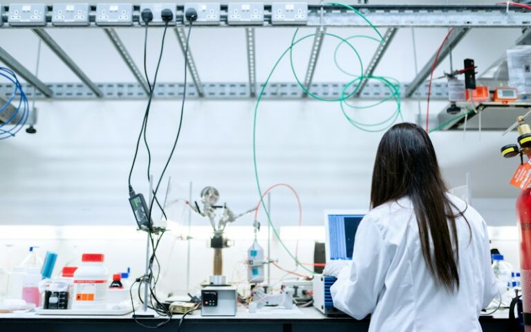 Laboratory engineer working beside analytical equipment, illustrating a regulated GC-MS quality-control workflow; photo by ThisisEngineering on Unsplash.