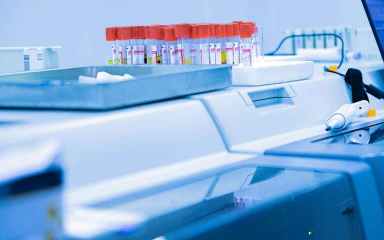 Labeled specimen containers in a laboratory, representing public health testing and surveillance workflows