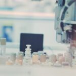 Automated analytical laboratory equipment illustrating a regulated LC-MS quality-control workflow; no named product is depicted